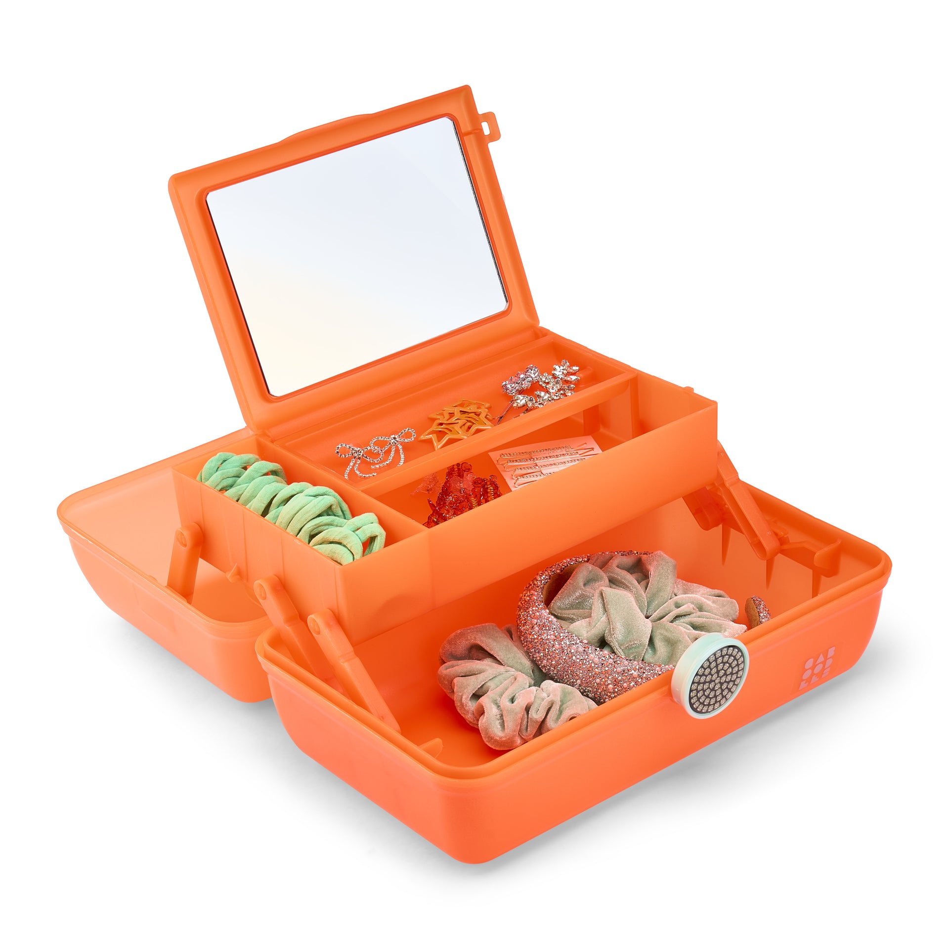 Orange jewelry box with mirror lid containing hair accessories on a white background